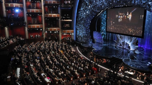 90th Academy Awards - Oscars Show - Hollywood, California, U.S., 04/03/2018 - Host Jimmy Kimmel and actors are shown on the big screen as they deliver candy to people in a movie theatre next door to the Dolby Theatre