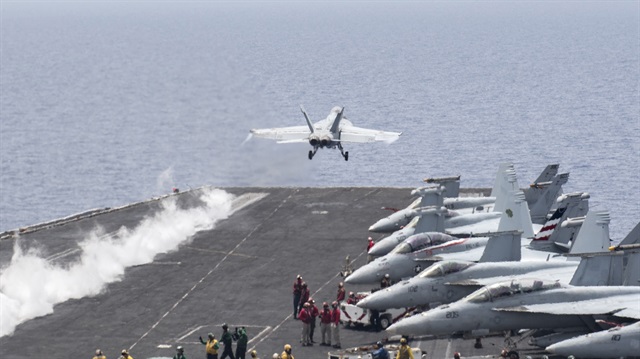 A U.S. Navy F/A-18E Super Hornet fighter jet launches from the flight deck 
