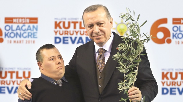 Mersin’de Cumhurbaşkanı Erdoğan’a konuşması sonrasında platforma gelen bir genç tarafından zeytin dalı hediye edildi.
