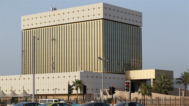 Cars drive past the building of Qatar Central Bank in Doha, Qatar