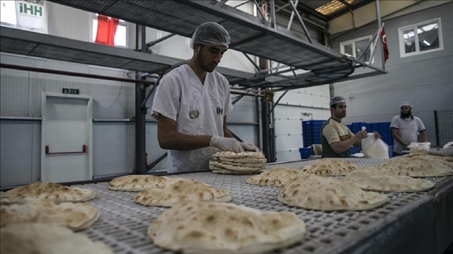 Workers make breads as Humanitarian Relief Foundation (IHH) provide relief supply kits including food, water, clothes and many other humanitarian aids from benefactors, at the the Cilvegozu Border Gate in Hatay's Reyhanli district of Turkey on November 16, 2017.