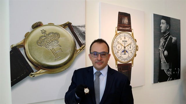 Remy Julia, Head of Watches for Christie's, Middle East, India and Africa, displays the Patek Philippe 18k gold perpetual chronograph wrist watch with moon phases belonging to the King Farouk, at the Christie's auction in Dubai, United Arab Emirates, March 19, 2018.