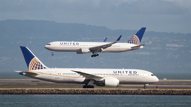 File Photo: A United Airlines aircraft taxis as another lands at San Francisco International Airport, San Francisco, California