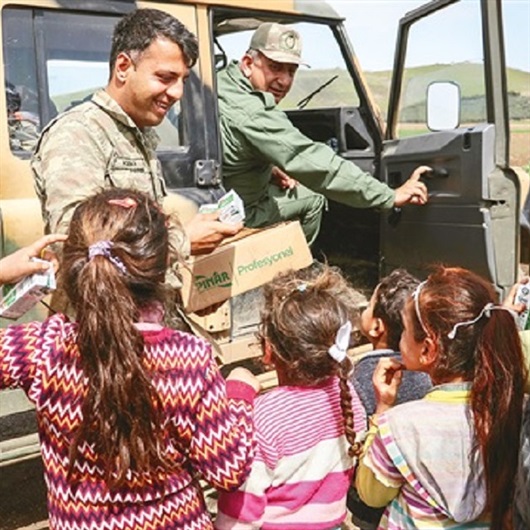 Turkish troops go door to door, distributing aid to Afrin residents