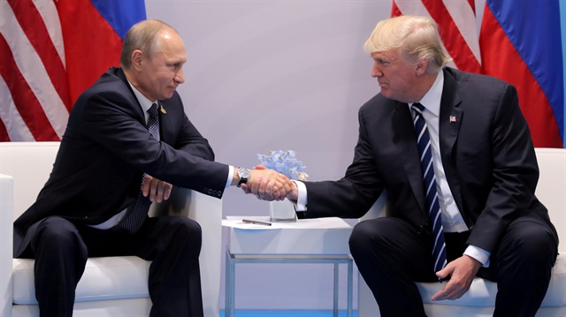 U.S. President Donald Trump shakes hands with Russia's President Vladimir Putin.