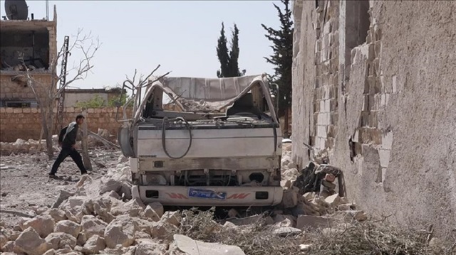 A damaged vehicle is seen after war planes carried out airstrikes over the Kefer Battih village of Idlib's Serakib town, Syria on March 21, 2018.
