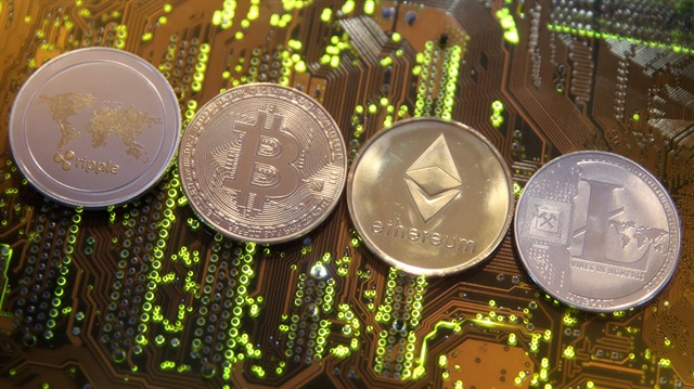File Photo: Representations of the Ripple, Bitcoin, Etherum and Litecoin virtual currencies are seen on motherboard in this illustration picture