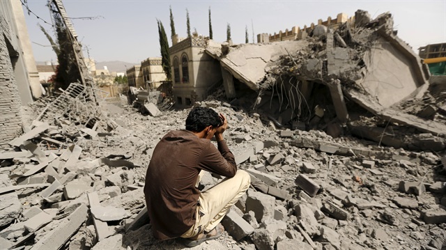 File Photo: Guard sits on the rubble of the house of Brigadier Fouad al-Emad, an army commander loyal to the Houthis, after air strikes destroyed it in Sanaa, Yemen