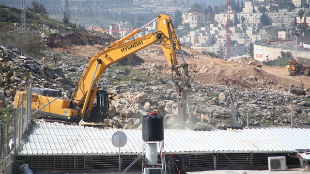 File Photo: A heavy duty machine that belongs to Israeli forces demolishes a Palestinian family's house with the claim of being unlicensed in the Shuafat neighborhood, Eastern Jerusalem on February 21, 2018.