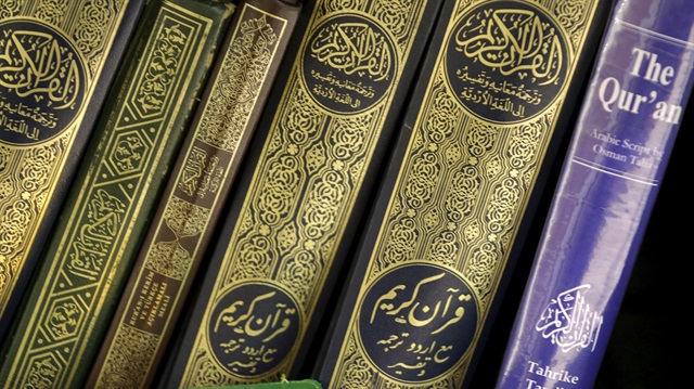 Copies of the Quran rest on a book shelf 