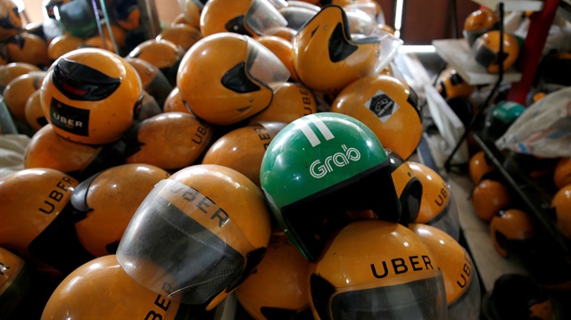 Used Grab and Uber helmets are seen at used-helmet shop in Jakarta, Indonesia, April 2, 2018. 