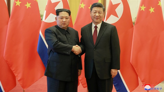 North Korean leader Kim Jong Un shakes hands with Chinese President Xi Jinping, as he paid an unofficial visit to Beijing, China, in this undated photo released by North Korea's Korean Central News Agency (KCNA) in Pyongyang March 28, 2018. 
