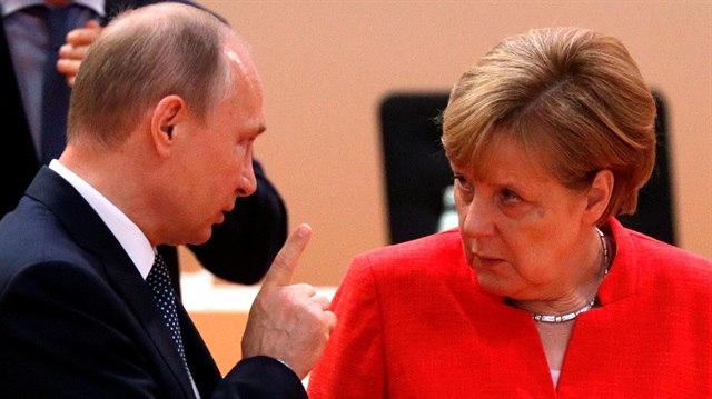 File Photo: Russia's President Vladimir Putin talks to German Chancellor Angela Merkel