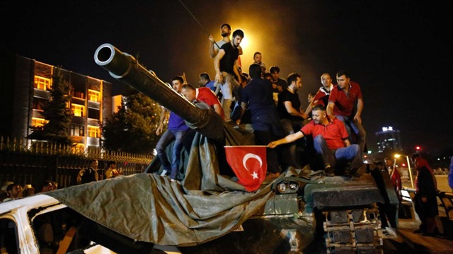 People stand on a Turkish army tank in Ankara during the attempted military coup in Turkey in July 2016.