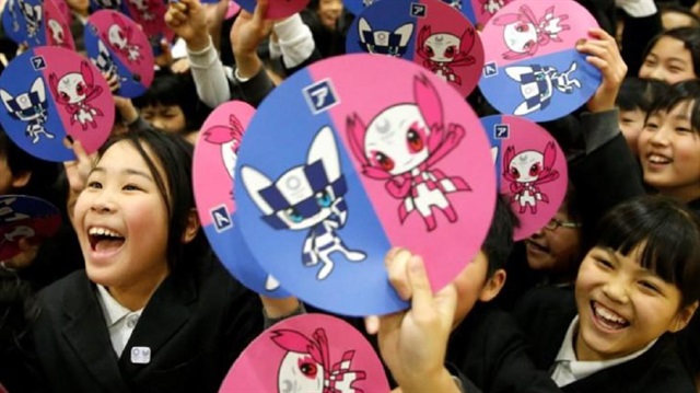 School students hold paper fans featuring the mascots for the Tokyo 2020 Olympics and Paralympics after Tokyo Olympics organizers unveiled the mascots selected by popular vote by elementary students across Japan at the Hoyonomori Gakuen School in Tokyo, Japan, February 28, 2018.