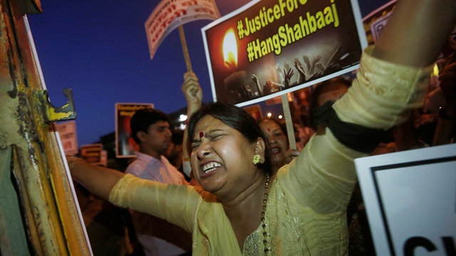 A woman shouts slogans during a protest against the rape of a ten-year-old girl