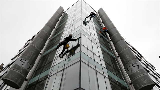 File Photo: Window cleaners work outside the offices of Cambridge Analytica in central London, Britain, March 24, 2018.