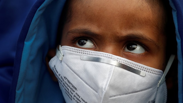 File Photo: A child wears a face mask for protection from air pollution in Delhi, India November 14, 2017.