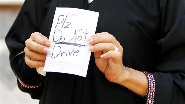 Female driver Azza Al Shmasani displays a note