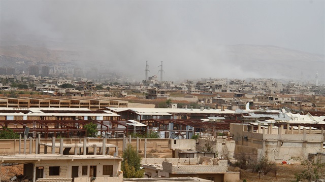 Smoke rises from Yarmouk Palestinian camp in Damascus, Syria