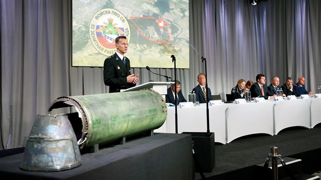 Dutch police officer Wilbert Paulissen, head of the National Crime Squad, is pictured next to a damaged missile as he presents interim results in the ongoing investigation of the 2014 MH17 crash that killed 298 people over eastern Ukraine, during a news conference by members of the Joint Investigation Team, comprising the authorities from Australia, Belgium, Malaysia, the Netherlands and Ukraine, in Bunnik, Netherlands, May 24, 2018. 