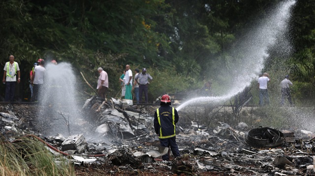 Firefighters work in the wreckage of a Boeing 737 plane that crashed in the agricultural area 

