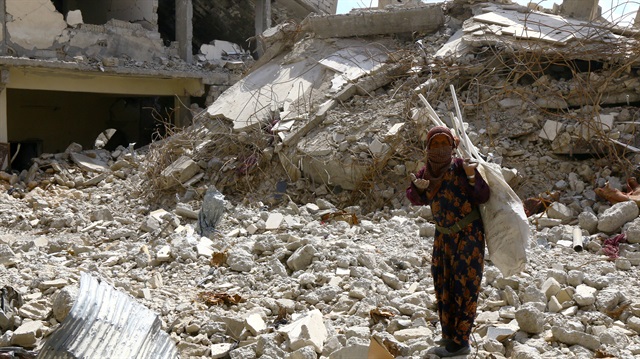 File Photo: A woman gestures as she stands on rubble of damaged buildings in Raqqa, Syria May 14, 2018.
