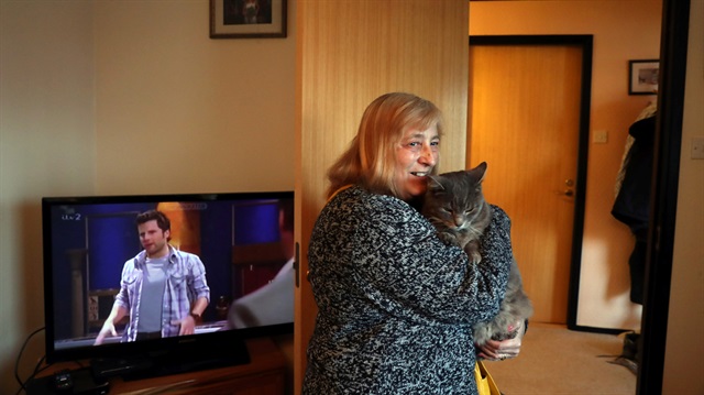 Susan Hurley pets her cat Achilles at her home in Port Stanley, Falkland Islands, May 18, 2018. 