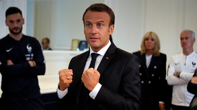 French President Emmanuel Macron speaks to the French national soccer team players, as goalkeeper Hugo Lloris (L), his wife, Brigitte Macron (2ndR) and head coach Didier Deschamps (R) look on during a meeting at France's training camp in Clairefontaine, near Paris, France, June 5, 2018 prior to the national team's participation to the 2018 FIFA World Cup Russia