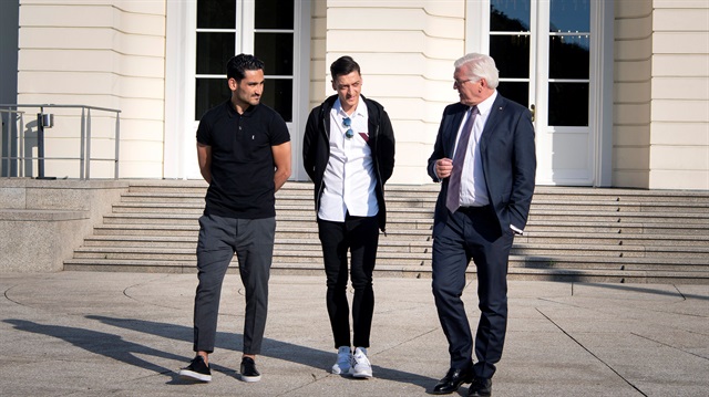 File Photo: German President Frank-Walter Steinmeier talks to national team players Ilkay Gundogan and Mesut Ozil during a meeting at Bellevue Castle in Berlin, Germany, May 19, 2018.