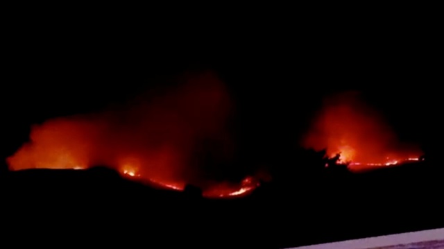 A fire is seen in Voltaire Canyon, outside Canyon City, Nevada, U.S., June 12, 2018 in this still image obtained from a social media video. 