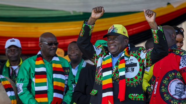 Zimbabwean President Emmerson Mnangagwa greets supporters before an explosion 