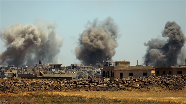 Smoke rises from al-Harak town, as seen from Deraa countryside, Syria June 25, 2018. 