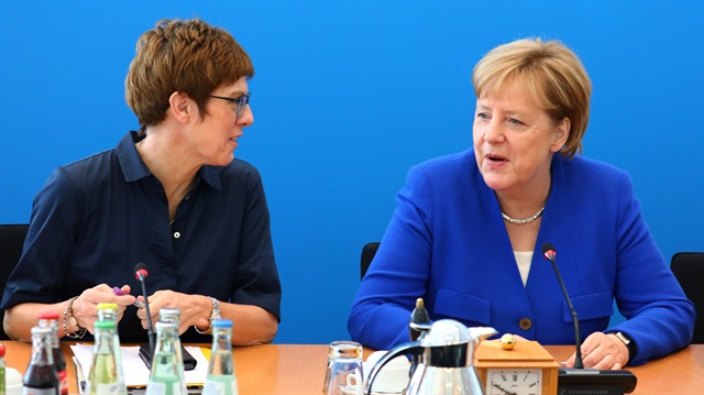 German Chancellor Angela Merkel talks to secretary general Annegret Kramp-Karrenbauer before a Christian Democratic Union (CDU) leadership meeting in Berlin, Germany, July 2, 2018.