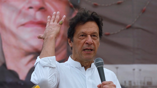 Imran Khan (2nd R), chairman of the Pakistan Tehreek-e-Insaf (PTI) political party