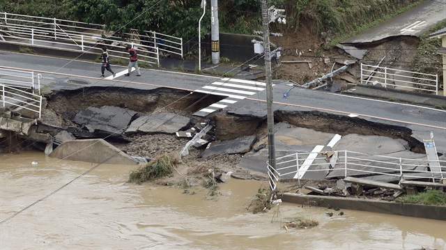 A broken road is seen after heavy rain in Kurashiki, Okayama Prefecture, Japan
