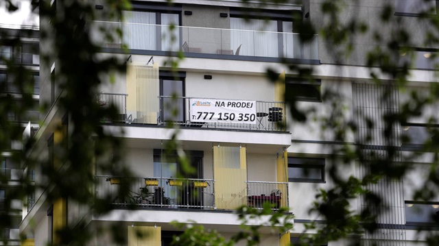 File Photo: A real estate "For Sale" sign is seen hanging outside an apartment building in Prague, Czech Republic.