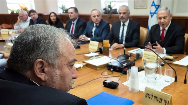 Israeli Defence Minister Avigdor Lieberman (L) sits opposite of Israeli Prime Minister Benjamin Netanyahu during the weekly cabinet meeting at the prime minister's office in Jerusalem.
