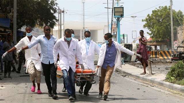 File Photo: Paramedics evacuate an unidentified injured man from the scene of a suicide car bombing near Somalia's presidential palace in Mogadishu, Somalia.