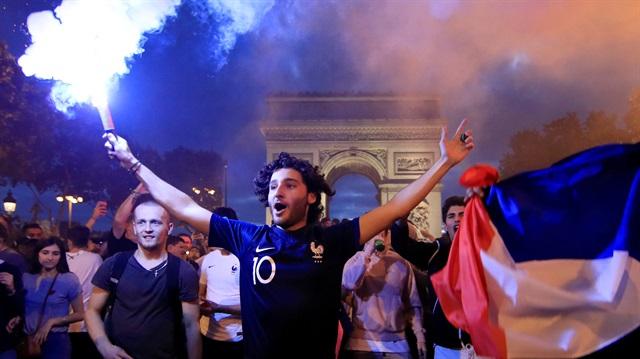 France fans react on the Champs-Elysees after defeating Belgium in their World Cup semi-final match. 