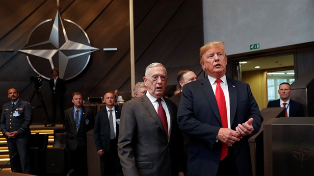 U.S. President Donald Trump walks in with U.S. Defense Secretary Jim Mattis as they arrive to attend the multilateral meeting of the North Atlantic Council in Brussels.