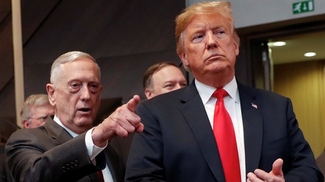 U.S. President Donald Trump walks in with U.S. Defense Secretary Jim Mattis.