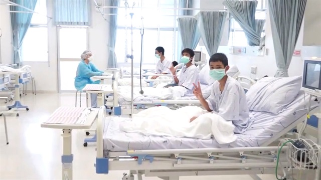 A screen grab shows boys rescued from the Thai cave wearing mask and resting in a hospital in Chiang Rai, Thailand.