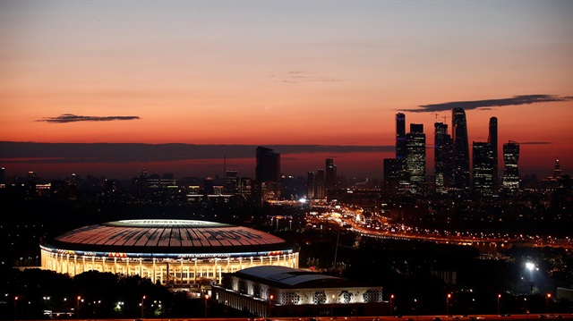 The illuminated Luzhniki stadium and the skyscrapers of the Moscow International Business Centre, also known as "Moskva-City", are seen just after sunset before the upcoming World Cup final between France and Croatia in Moscow, Russia.