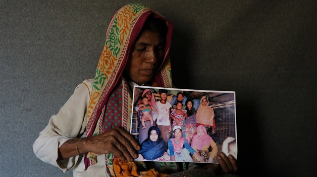 File Photo: Ayesha Khatun, a Rohingya refugee, holds a family picture that she has sent to her husband and son jailed in Sittwe prison in Myanmar as a reply message, in Cox's Bazar, Bangladesh, July 5, 2018.