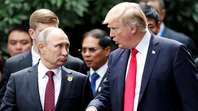 FILE PHOTO: U.S. President Donald Trump and Russia's President Vladimir Putin talk during the family photo session at the APEC Summit in Danang, Vietnam November 11, 2017.