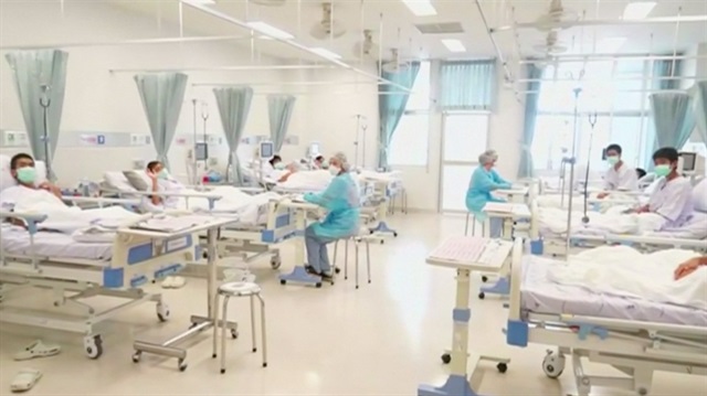 Boys rescued from the Thai cave wear masks and rest at a hospital in Chiang Rai, Thailand.