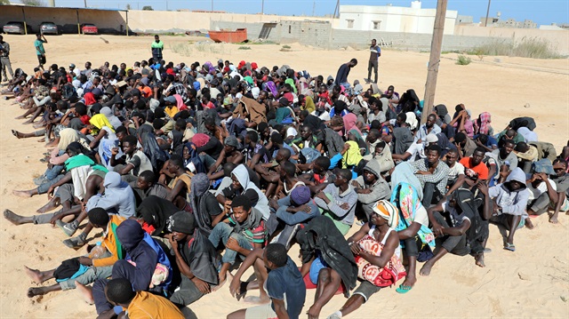 File photo: Migrants sit at a detention center in Zuwarah