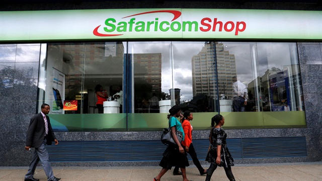 File photo: Pedestrians walk past a mobile phone care centre operated by Kenyan's telecom operator Safaricom in the central business district of Kenya's capital Nairobi.