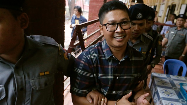 Detained Reuters journalist Wa Lone is escorted by police officers as he leaves the Insein court in Yangon, Myanmar.